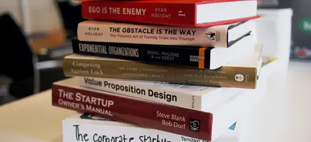 Professional book publishing workspace with open books and manuscripts